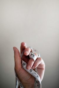hand with measuring tape