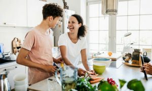 couple cooking laughing