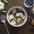 bowl of cereal with banana blueberries pecans