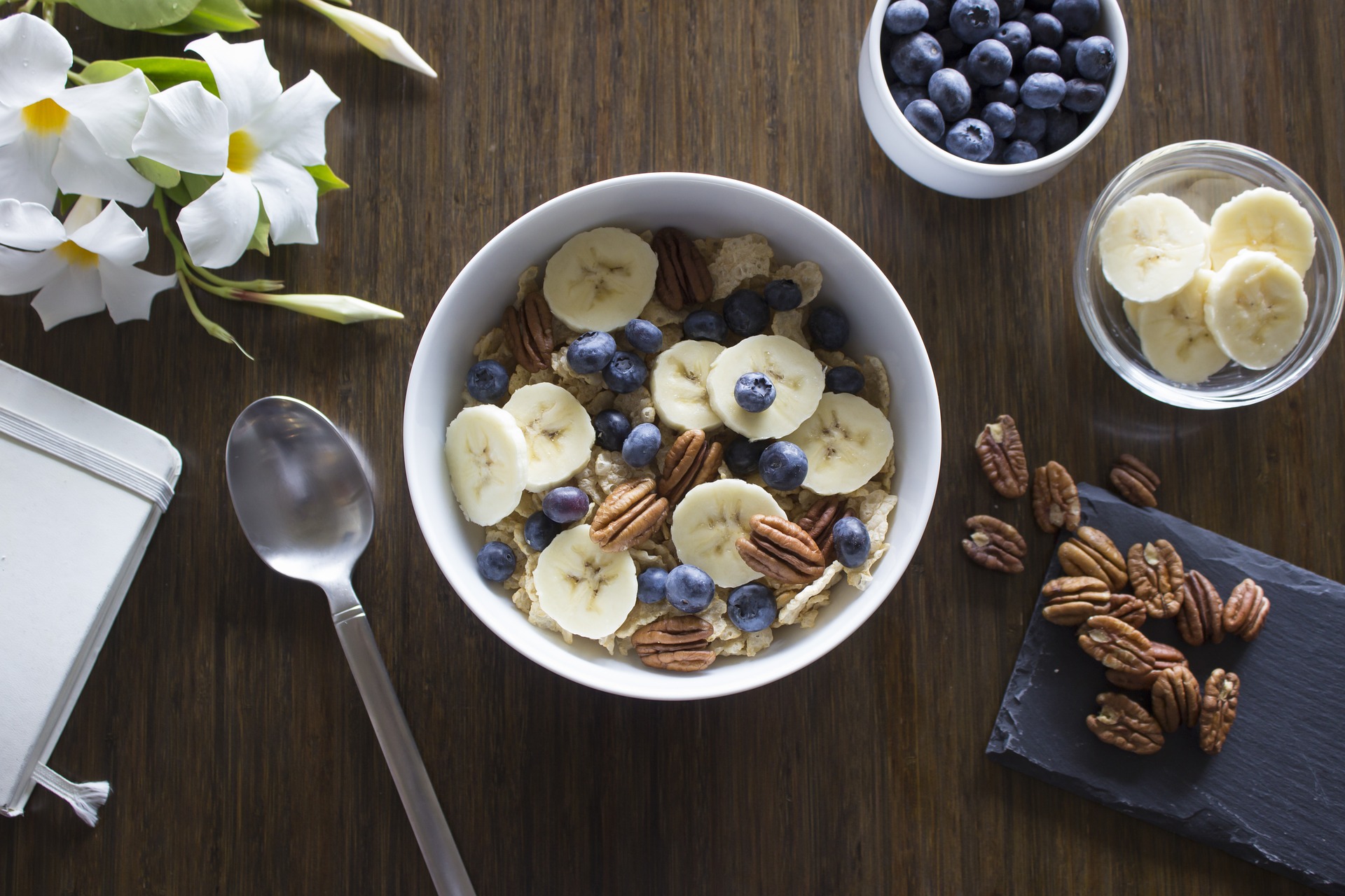 bowl of cereal with banana blueberries pecans